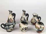 several different types of vases are displayed on a white surface