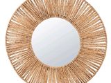 a round mirror that is made out of rattan