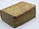 an old book sitting on top of a white table