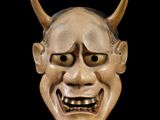 an image of a wooden mask with horns on a black background