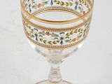 a close up of a glass with a gold rim on a white background