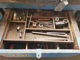 a drawer full of tools in a garage