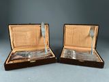 pair of silver plated forks and spoons in a case