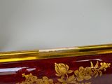 a red and gold case with gold flowers on it