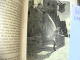 an old book with a picture of a boy playing baseball