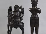 pair of bronze figurines of a seated woman and a seated man