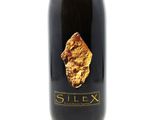 an image of a bottle of wine with a gold leaf on it