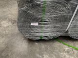 several rolls of wire wrapped in plastic sitting on top of a pallet