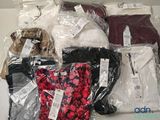 a lot of clothes that are wrapped in plastic bags