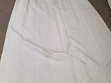 the skirt is laying on the table next to a bottle of water