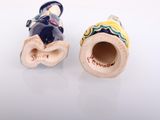 pair of small ceramic figurines of a man and a woman