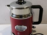 a red coffee pot sitting on top of a white counter