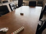 a table with a remote control on it in a conference room