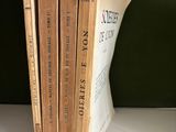 three books are stacked on top of each other on a shelf