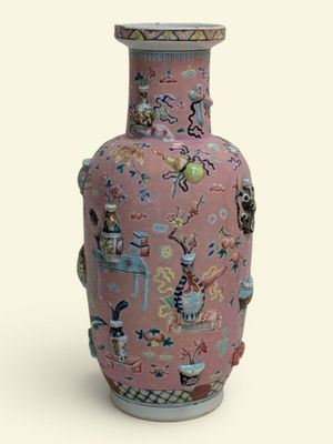 un vase rose orné d'un motif sur fond blanc