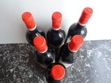 several bottles of wine are lined up on a counter top