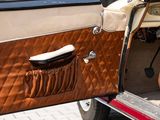 a close up of a car door with a brown leather cover