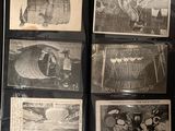 a lot of old black and white photos on a table