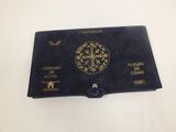 an old black book with a gold cross on it
