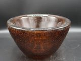 a brown bowl sitting on top of a table