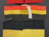 two pieces of cloth with a red, yellow and black stripe