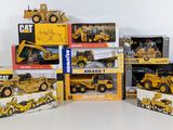 a lot of construction vehicles that are sitting on top of each other