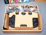 a cardboard box with two game controllers inside of it
