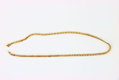 a gold chain on a white background