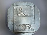 an image of a metal object with a man and a woman on it