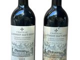 two bottles of wine that are sitting next to each other