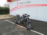 a black motorcycle parked in a parking lot next to a building