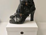 a pair of black high heeled shoes on a white box