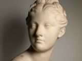 marble bust of a woman with a braided hair