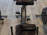a row of stationary exercise bikes in a gym