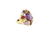 a close up of a gold ring with a purple and green stone