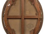 an old wooden circular window with a hole in the middle