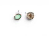 a pair of earrings with a green stone in the middle