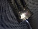 a fork that is sitting on top of a piece of metal