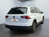 the rear end of a white volkswagen tiguan parked in a garage