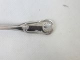 a silver spoon with a flower design on it