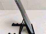 a cell phone sitting on a stand on a table