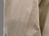 a close up of a man wearing a beige jacket