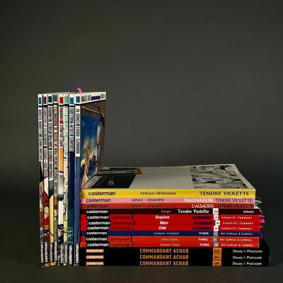 many books stacked on top of each other on a table