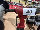 a picture of a drill and other tools on a table