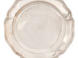silver plate with scalloped edge on a white background