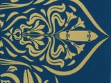 a picture of a blue and gold flower design on the wall