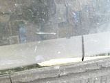 a cat that is sitting on the ledge of a window sill