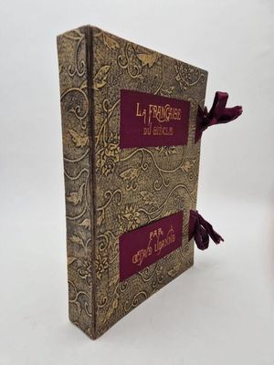 a close up of a book on a white surface with a red ribbon