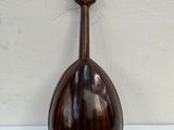 an image of a mandolin sitting on top of a white table