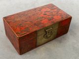 an old wooden box with a lock on it sitting on a table